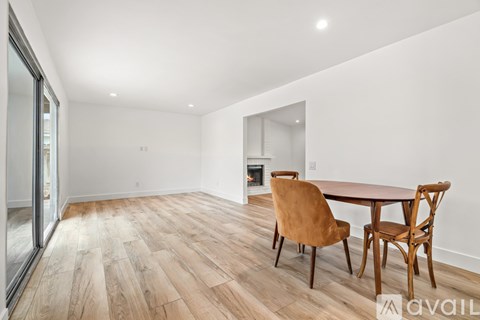 A dining room with a wooden table and chairs.