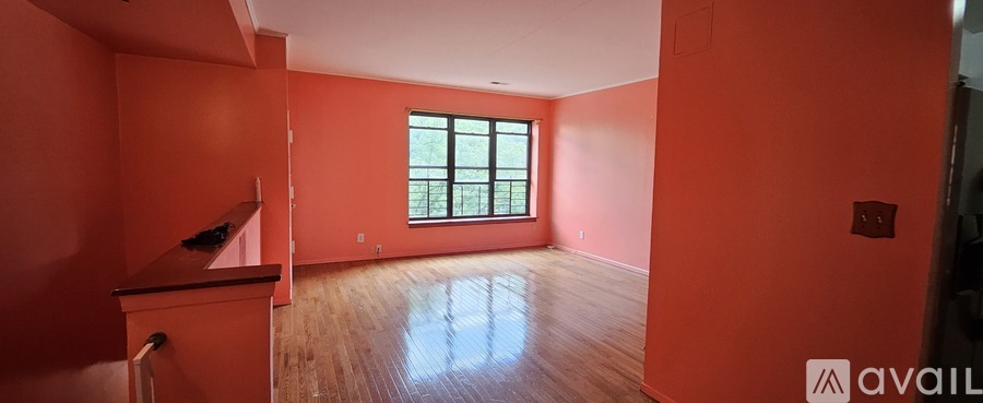 A room with orange walls and a window.