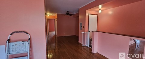 A room with a pink wall and a white door.