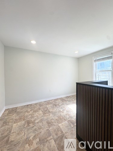 A room with a tiled floor and a window.