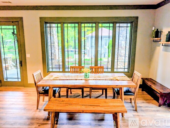 A dining room with a wooden table and chairs.