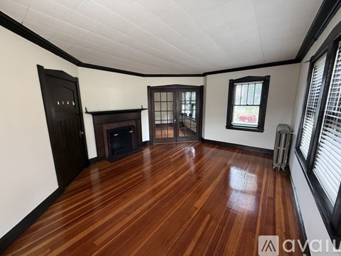 A room with wooden floors and a fireplace.