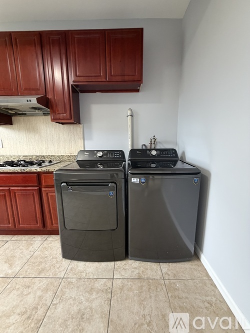 A kitchen with a stove top oven and a dishwasher.