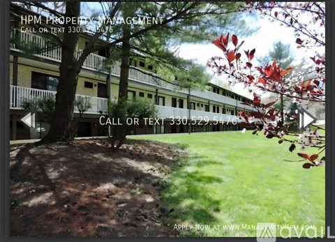 A leafy tree in front of a building with the text "HPM PROPERTY MANAGEMENT" and a phone number.