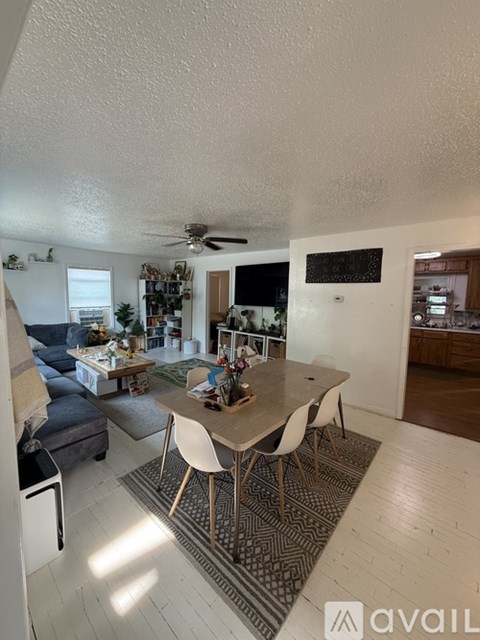 A living room with a dining table and chairs.