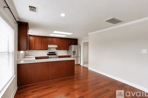 A kitchen with wooden cabinets and a white countertop.