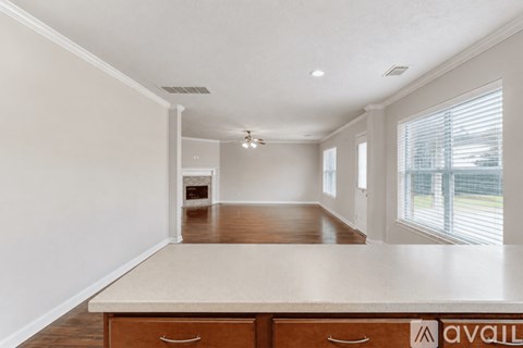 A spacious room with a long counter and drawers.
