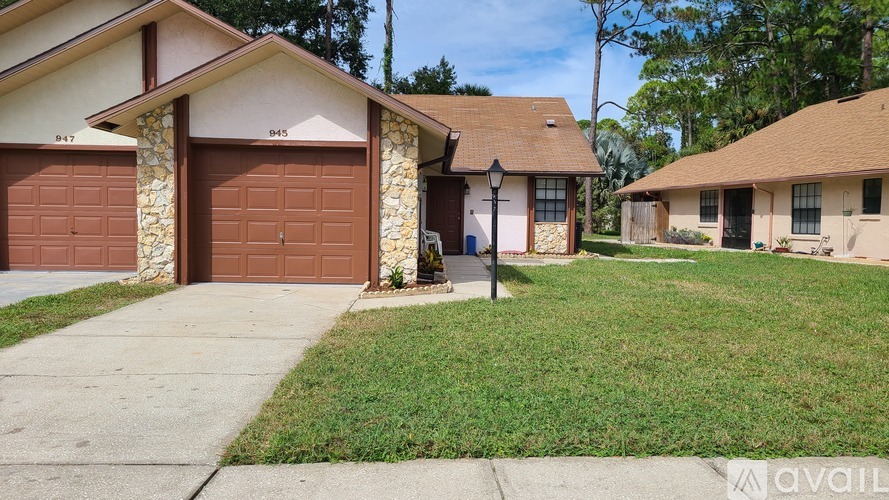A house with a brown garage door is for sale.