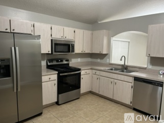A kitchen with white cabinets and stainless steel appliances.