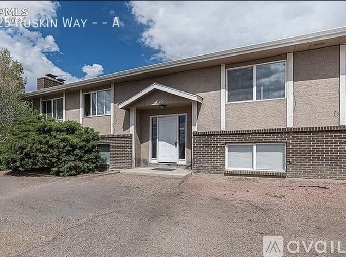 A house with a white door and windows is for sale.