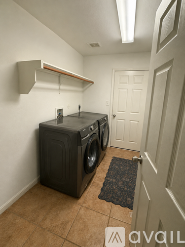 A laundry room with a washer and dryer.