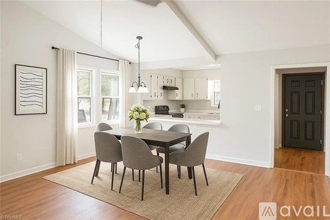 A dining room with a table set for four.