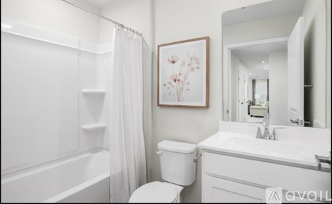 A white bathroom with a toilet, sink, and bathtub.