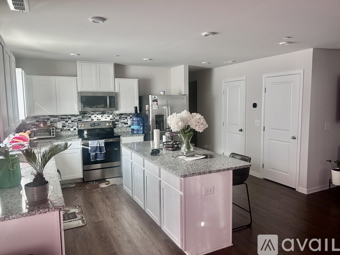 A kitchen with a granite countertop and a pink cabinet.