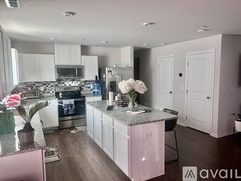 A kitchen with a granite countertop and a pink cabinet.