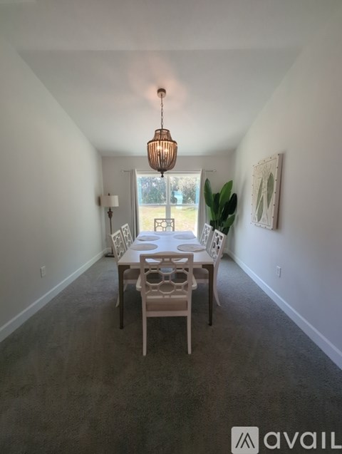 A dining room with a table set for four.