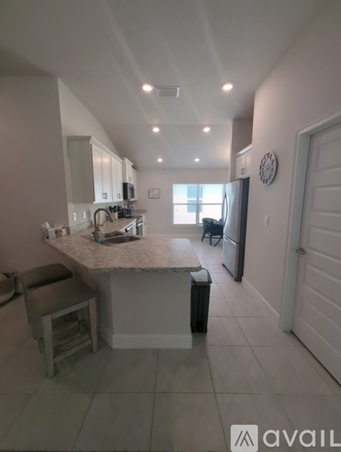 A kitchen with a counter and a bar stool.