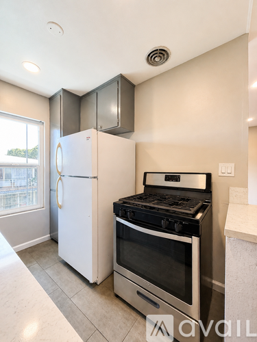 A kitchen with a white refrigerator and stove.