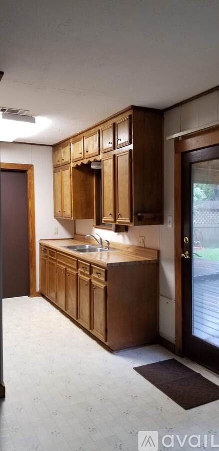 A kitchen with wooden cabinets and a sink.