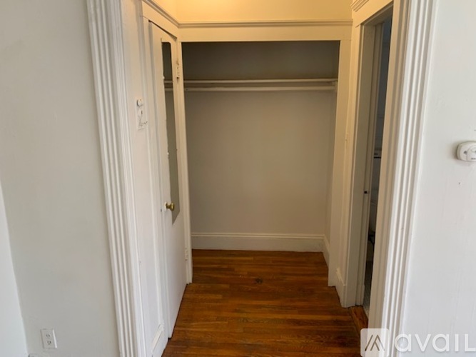 A room with a wooden floor and white walls.