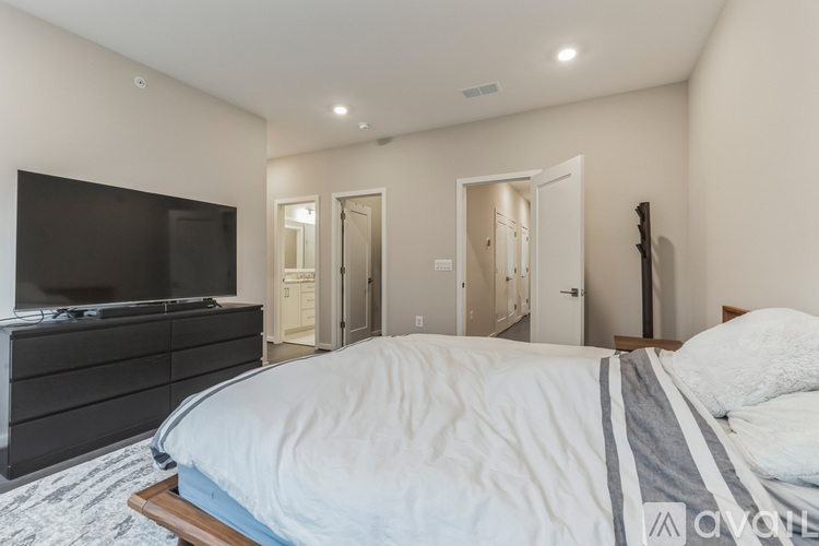 A bedroom with a large bed and a television.