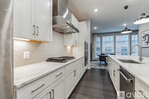 A modern kitchen with white cabinets and a large island.