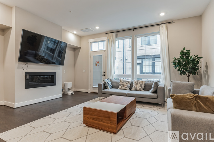 A living room with a fireplace and a television on the wall.