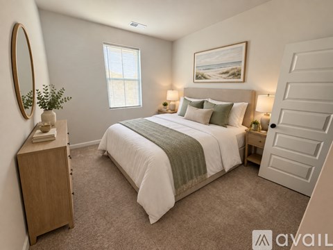 A well-lit bedroom with a large bed and a wooden dresser.