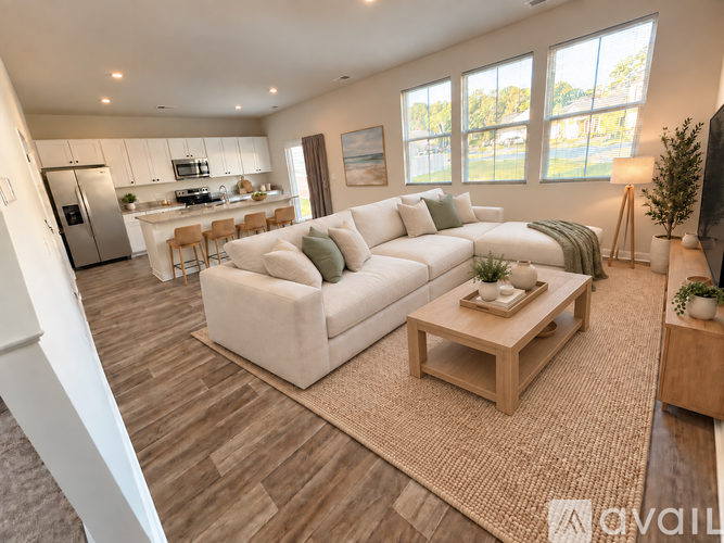 A living room with a white couch and a wooden coffee table.