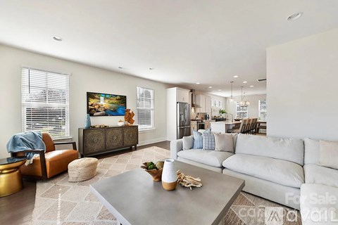 A living room with a grey sofa and a grey coffee table.