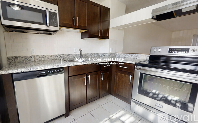 A kitchen with a stainless steel dishwasher and oven.
