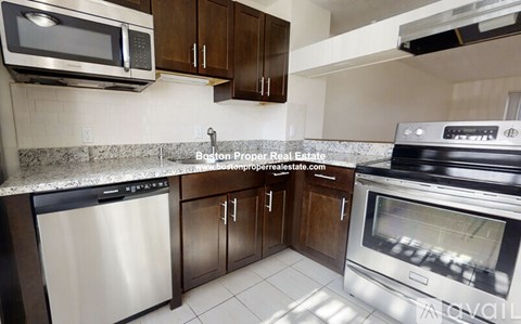 A kitchen with a stainless steel dishwasher and oven.