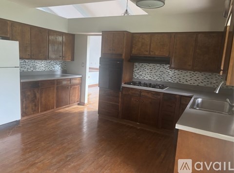 A kitchen with wooden cabinets and a white fridge.