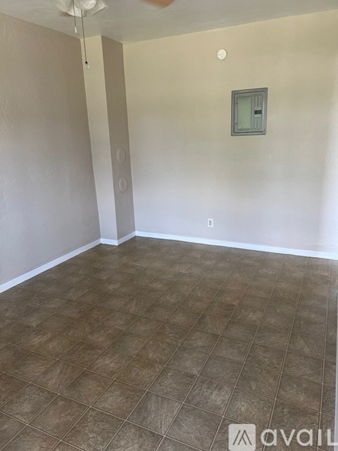 A room with a tiled floor and a small window on the wall.