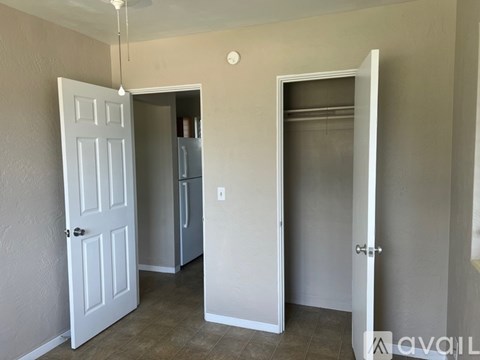A room with a white door, a white cabinet, and a white wall.