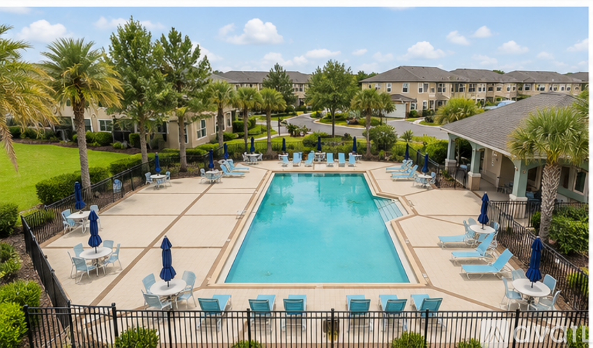 A large swimming pool surrounded by lounge chairs and umbrellas.