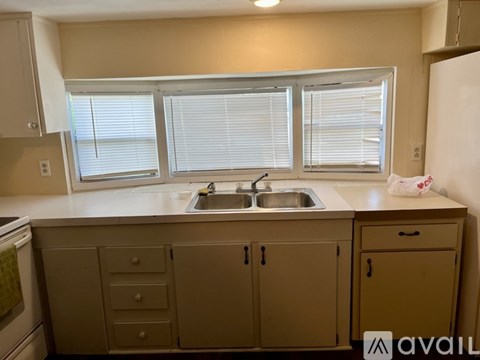 A kitchen with a sink and a window.