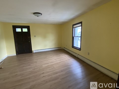 A room with wooden flooring and a window.
