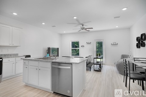 A modern kitchen with a large island and a dining area.