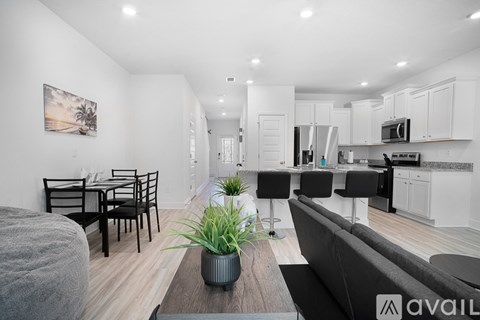 A modern living room with a grey couch and a wooden coffee table.