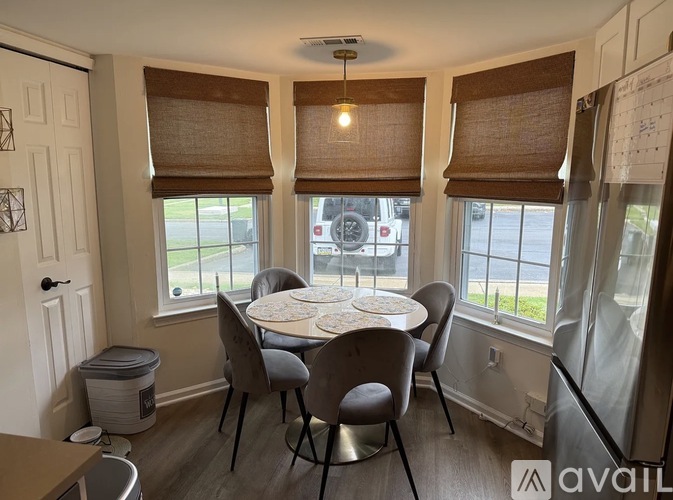 A dining room with a table and chairs.