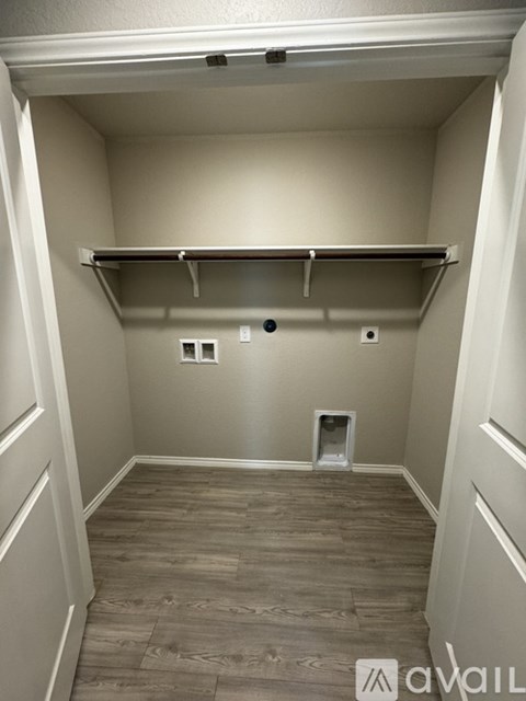 A small, empty room with a shelf and a vent.