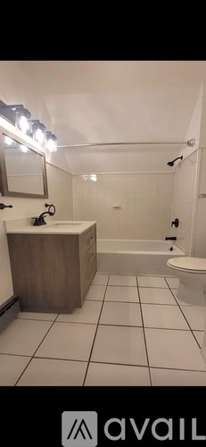 A bathroom with a white toilet, sink, and bathtub.