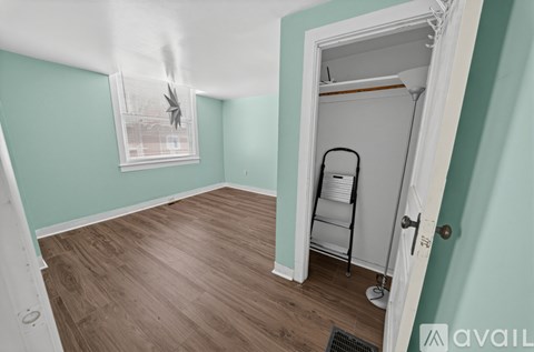 A room with a wooden floor and a white door.