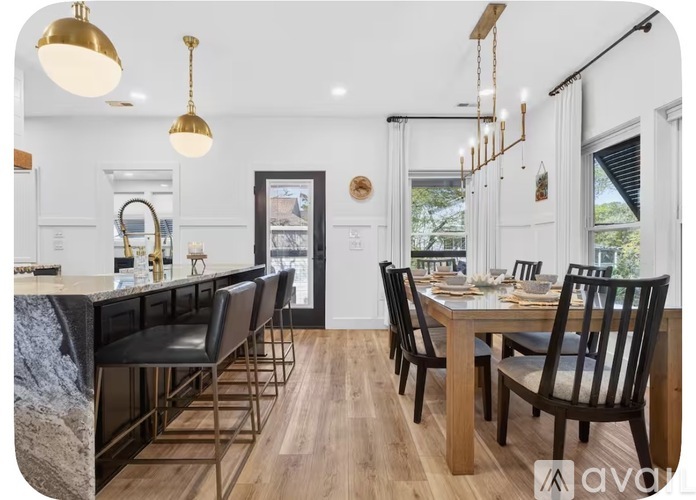 A modern kitchen with a dining table set for four.
