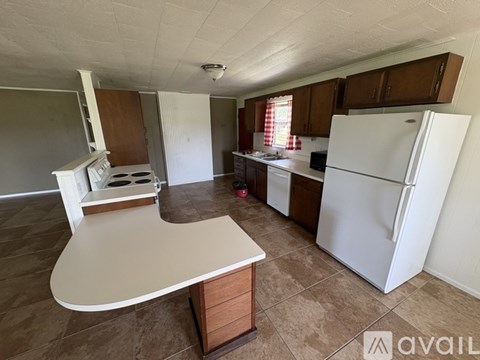 A kitchen with a white fridge and a white counter.