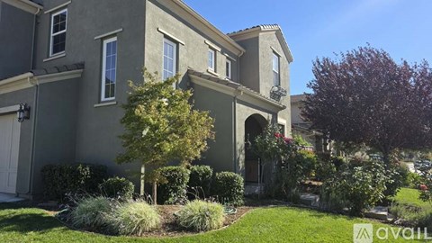 A house with a tree in front of it.