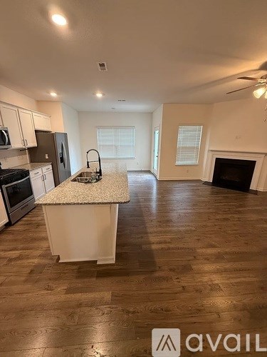 A kitchen with a white island in the middle of the room.
