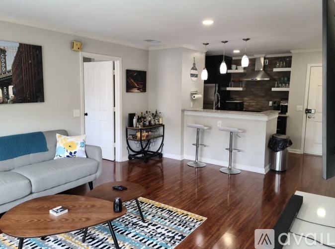 A living room with a grey couch and a coffee table.