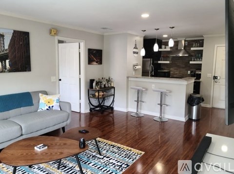 A living room with a grey couch and a coffee table.